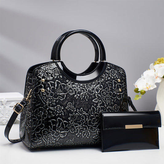 Black floral-embossed structured tote bag set with matching pouch