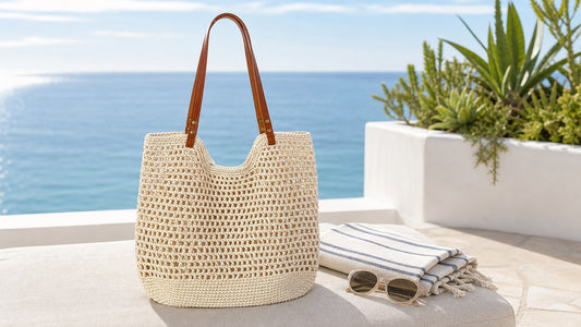 Cream hollow mesh cotton woven beach tote with brown handles on a coastal terrace