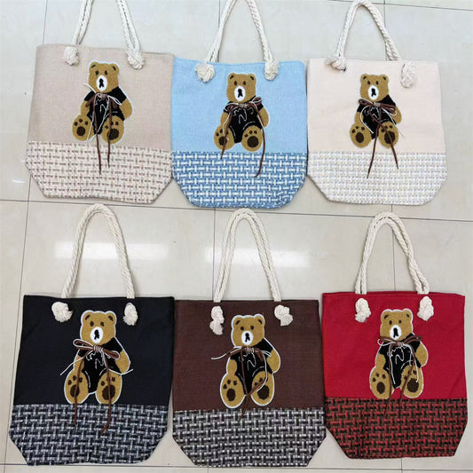 Teddy bear applique rope-handle tote bags shown in six colors